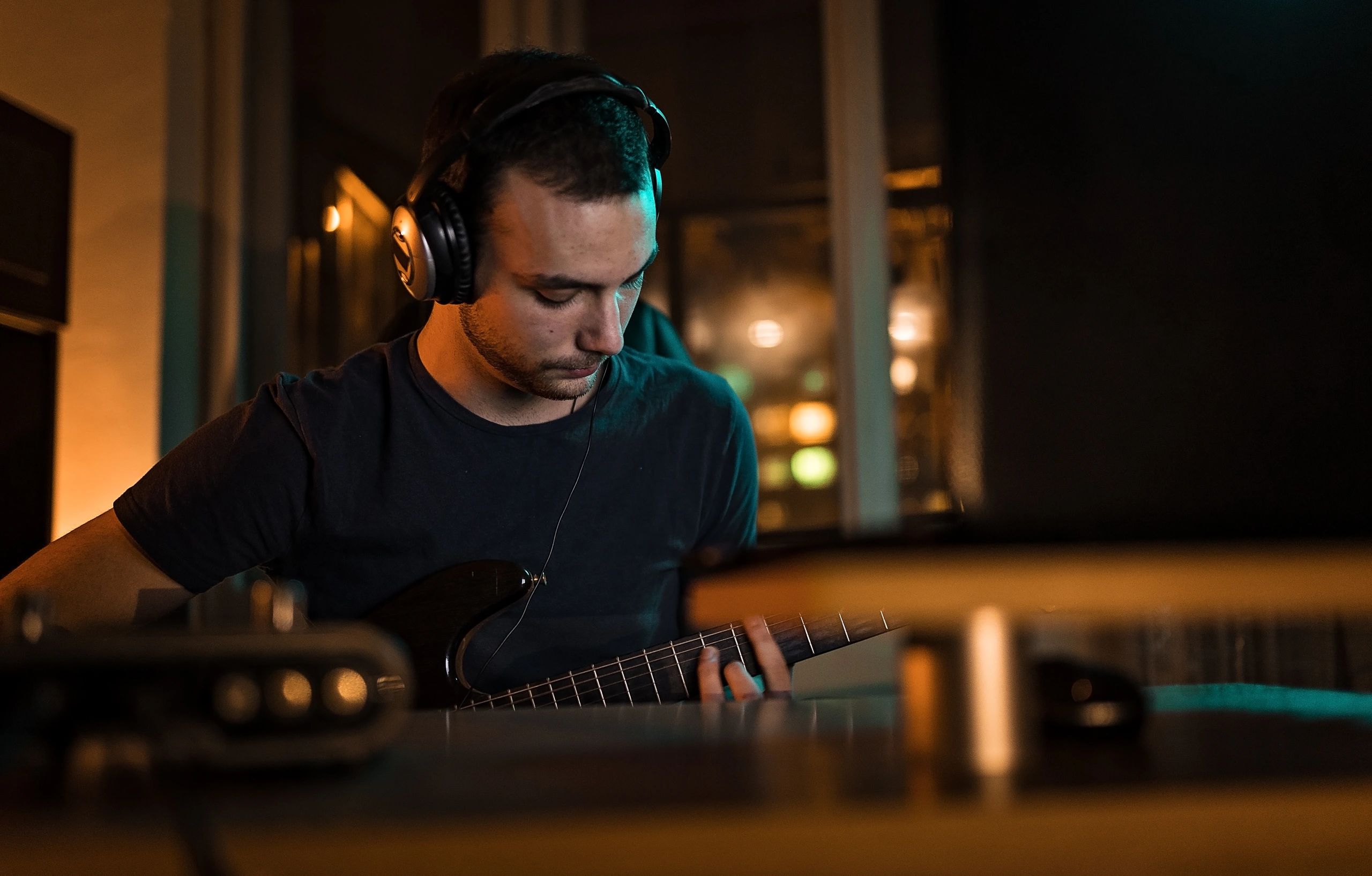 Musician recording guitar in a studio environment