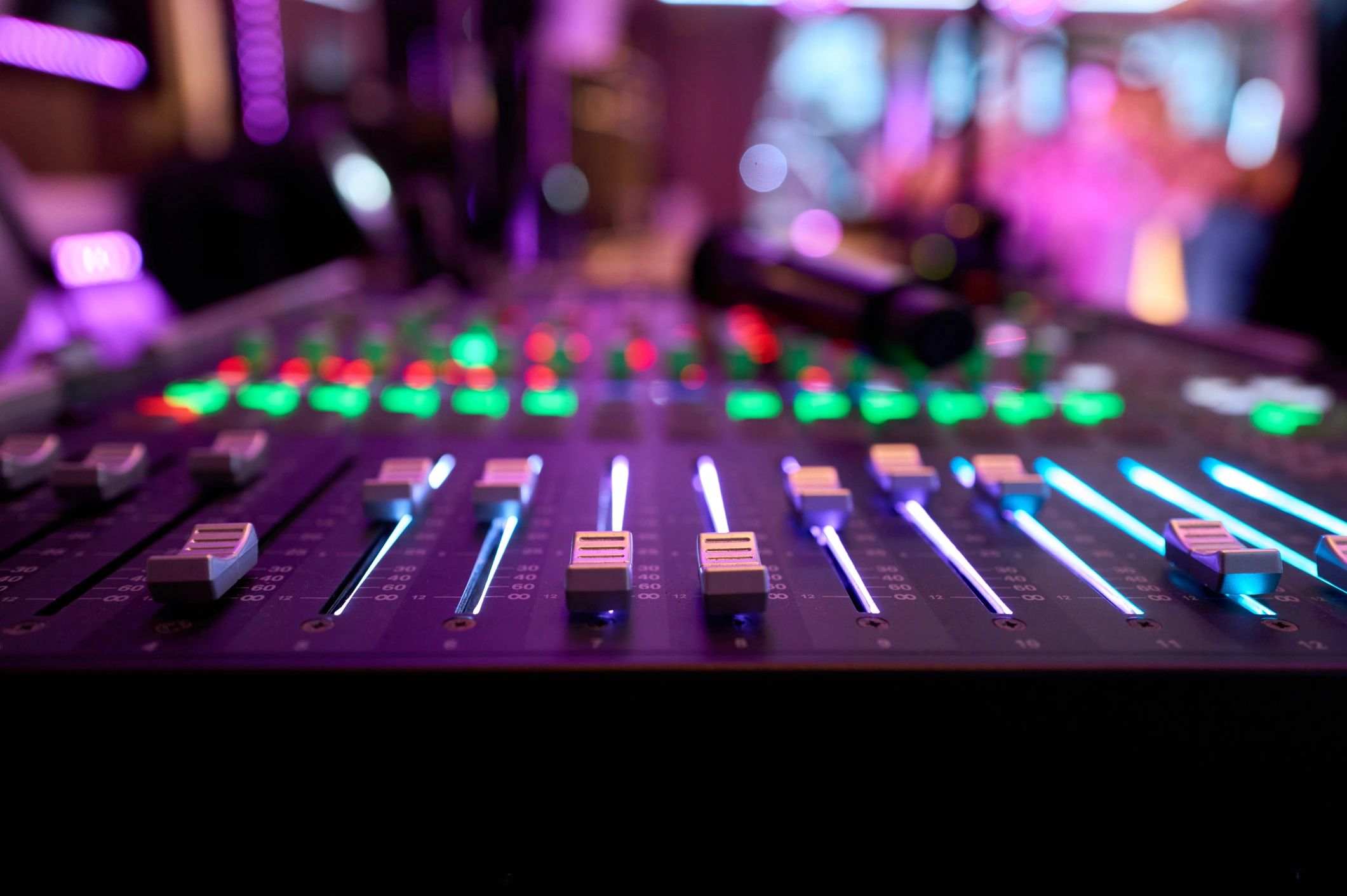Professional audio mixer with colorful lights in a recording studio