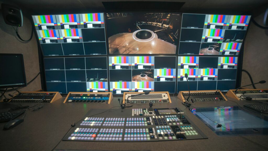 Professional broadcast control room with video switcher and multiview monitors with copy space